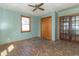 Bedroom with light blue walls, hardwood floors, closet, and French doors to another room at 218 Illinois St, Shirley, IN 47384