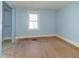 Bright blue bedroom with hardwood floors, closet, and a window providing natural light at 218 Illinois St, Shirley, IN 47384
