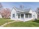 Charming single Gathering home with white siding, gray roof, and colorful landscaping at 218 Illinois St, Shirley, IN 47384