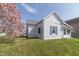Charming single Gathering home with white siding, gray roof, and colorful landscaping at 218 Illinois St, Shirley, IN 47384
