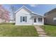 Charming single Gathering home with white siding, gray roof, and colorful landscaping at 218 Illinois St, Shirley, IN 47384
