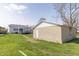Backyard photo of the house and a detached garage with white door at 218 Illinois St, Shirley, IN 47384