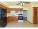 Traditional kitchen with wooden cabinets, black appliances, and neutral tile flooring at 218 Illinois St, Shirley, IN 47384