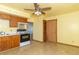 Bright kitchen featuring oak cabinets, tile flooring, and standard appliances with a ceiling fan at 218 Illinois St, Shirley, IN 47384