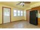 Eat-in kitchen area with tiled flooring, wooden trim, ceiling fan, and natural light from a large window at 218 Illinois St, Shirley, IN 47384