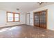 Spacious living room featuring a ceiling fan and glass panel doors at 218 Illinois St, Shirley, IN 47384
