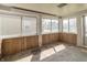 Sun room with wood paneling, multiple windows, and abundant natural light at 218 Illinois St, Shirley, IN 47384