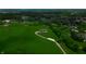 An aerial view shows a house with a long driveway surrounded by green grass at 2428 S Morgantown Rd, Greenwood, IN 46143