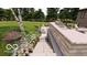 Backyard with a stone outdoor kitchen, lounge chairs, and swimming pool in an upscale design at 2428 S Morgantown Rd, Greenwood, IN 46143