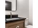 Bathroom vanity featuring dark countertop, wood cabinet, and modern faucet at 2428 S Morgantown Rd, Greenwood, IN 46143