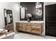 Luxurious bathroom featuring double vanities, modern lighting, and a freestanding tub with marble floors at 2428 S Morgantown Rd, Greenwood, IN 46143