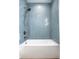 Stylish bathtub with blue tile walls and shower head for a relaxing and modern bathing experience at 2428 S Morgantown Rd, Greenwood, IN 46143
