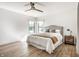 Bedroom with natural light, white walls, ceiling fan, and light wood grain flooring at 2428 S Morgantown Rd, Greenwood, IN 46143