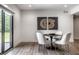 Dining area with white walls, abstract art, and round black table with four white chairs at 2428 S Morgantown Rd, Greenwood, IN 46143