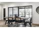Bright dining area with wood table, modern chairs, and sliding glass doors leading to a covered patio at 2428 S Morgantown Rd, Greenwood, IN 46143