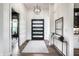 Elegant foyer with modern lighting, a console table, and a view into the adjacent living space at 2428 S Morgantown Rd, Greenwood, IN 46143