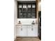 Kitchen featuring white cabinets, display cabinets, a black refrigerator, and under-cabinet lighting at 2428 S Morgantown Rd, Greenwood, IN 46143