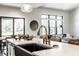 Modern kitchen island with bar stools, black sink, and large windows providing natural light at 2428 S Morgantown Rd, Greenwood, IN 46143