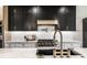 Modern kitchen with stainless steel appliances, gas range, black sink, and white subway tile backsplash at 2428 S Morgantown Rd, Greenwood, IN 46143