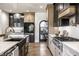 Modern kitchen with stainless steel appliances, gas range, white cabinets, and a black refrigerator at 2428 S Morgantown Rd, Greenwood, IN 46143