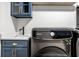 Stylish laundry area with modern sink, sleek cabinets, and a high-efficiency, front-load washing machine for added convenience at 2428 S Morgantown Rd, Greenwood, IN 46143