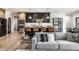 Cozy living space with a view into a modern kitchen featuring bar seating and contemporary design at 2428 S Morgantown Rd, Greenwood, IN 46143