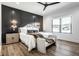Modern main bedroom with accent wall, wood floors, and an abundance of natural light at 2428 S Morgantown Rd, Greenwood, IN 46143