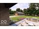 An outdoor kitchen, covered patio, and lush lawn area complete with mature trees at 2428 S Morgantown Rd, Greenwood, IN 46143