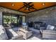 Covered patio with a brick wall, outdoor seating, ceiling fan, and grilling area at 2428 S Morgantown Rd, Greenwood, IN 46143