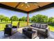 Inviting covered patio with comfortable seating and a view of the well-manicured lawn at 2428 S Morgantown Rd, Greenwood, IN 46143