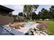A beautiful backyard featuring a pool, fire pit, and patio furniture with lush landscaping at 2428 S Morgantown Rd, Greenwood, IN 46143