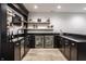 Home wet bar with dark cabinets, granite countertop, beverage coolers, and floating shelves at 2428 S Morgantown Rd, Greenwood, IN 46143