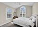 Bedroom featuring vaulted ceilings, two bright windows, and a comfortable bed at 2468 Wyndham S Pl, Columbus, IN 47203