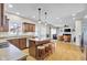 Open-concept kitchen with an island and barstools seamlessly connects to the inviting living area at 2468 Wyndham S Pl, Columbus, IN 47203