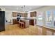 Spacious kitchen featuring a central island with seating, dark wood cabinets, and modern appliances at 2468 Wyndham S Pl, Columbus, IN 47203