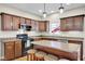 Traditional kitchen featuring wood cabinets, stone countertops and eat-in island with seating at 2468 Wyndham S Pl, Columbus, IN 47203