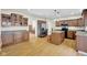 Spacious kitchen featuring abundant cabinetry, a central island, stainless steel appliances, and hardwood floors at 2468 Wyndham S Pl, Columbus, IN 47203