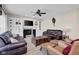 Beautifully staged living room with fireplace, built-ins, and comfortable leather furniture at 2468 Wyndham S Pl, Columbus, IN 47203
