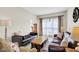 Comfortable living room with plush seating, a large window with sheer curtains, and warm, natural light at 2468 Wyndham S Pl, Columbus, IN 47203
