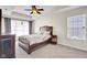 Main bedroom featuring a king bed, carpet and a ceiling fan at 2468 Wyndham S Pl, Columbus, IN 47203