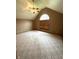 Bedroom with vaulted ceiling features a ceiling fan and a unique arched window that provides plenty of natural light at 2690 Trailridge Ct, Martinsville, IN 46151