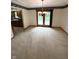 Dining room features neutral carpet, modern light fixture, sliding doors to the outdoor space, and access to the kitchen at 2690 Trailridge Ct, Martinsville, IN 46151