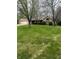 A charming brick home is framed by mature trees and a lush green lawn, showcasing suburban tranquility at 2690 Trailridge Ct, Martinsville, IN 46151