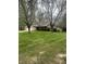 A charming brick home with green lawn and mature trees providing a picturesque suburban setting at 2690 Trailridge Ct, Martinsville, IN 46151