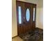 Elegant wooden front door featuring decorative glass panels, complemented by marble flooring and a neutral color scheme at 2690 Trailridge Ct, Martinsville, IN 46151