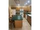 Well-equipped kitchen with island seating, white appliances, and wood cabinetry at 2690 Trailridge Ct, Martinsville, IN 46151