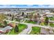 A wide shot shows houses with green lawns and tree cover in a suburban landscape at 2828 N Moreland Ave, Indianapolis, IN 46222