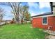 Well-maintained backyard with lush green grass and a brick home at 2828 N Moreland Ave, Indianapolis, IN 46222