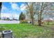 Image of a home's backyard featuring mature trees, a privacy fence, and an air conditioning unit at 2828 N Moreland Ave, Indianapolis, IN 46222