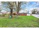 A spacious backyard featuring mature trees, a swing, and a well-maintained lawn at 2828 N Moreland Ave, Indianapolis, IN 46222